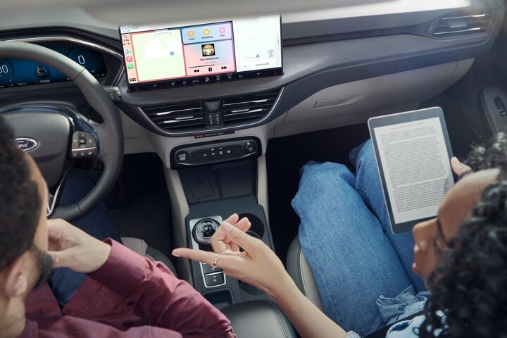 Interior shot of a 2023 Ford Escape® with a couple talking