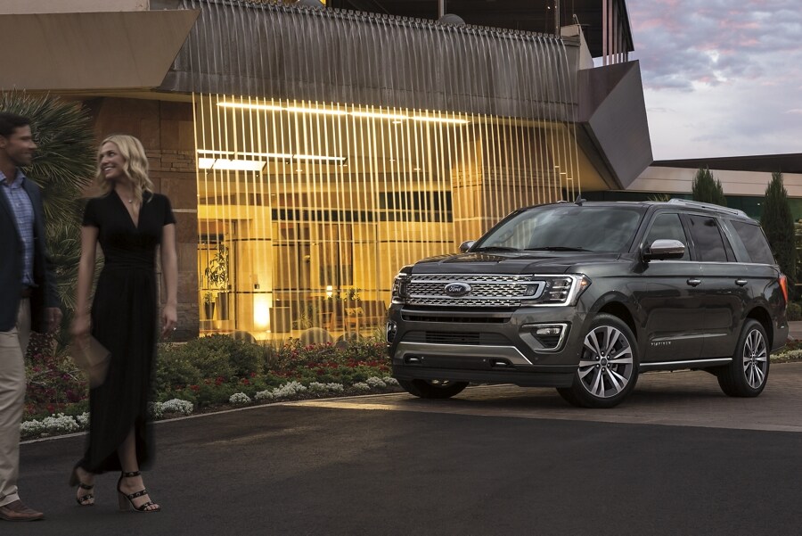 2021 Ford Expedition Platinum parked at night outside a lighted building 