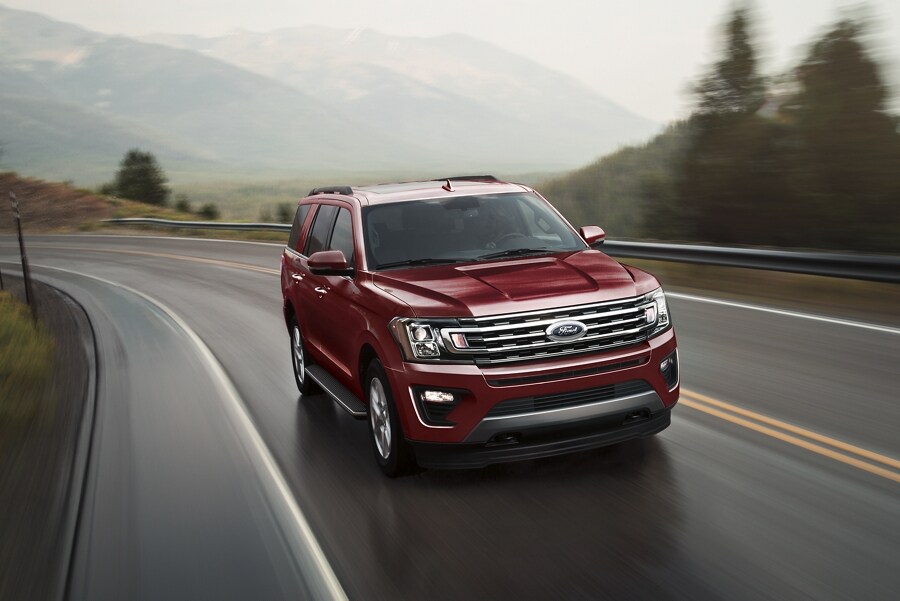 2021 Ford Expedition in Rapid Red Metallic Tinted Clearcoat being driven on a highway
