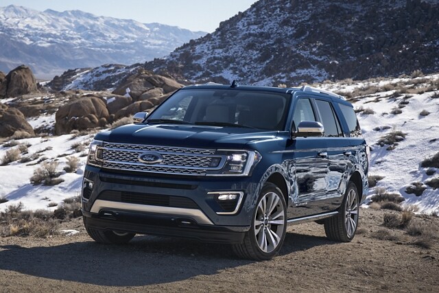 2021 Ford Expedition X L S T X in Antimatter Blue being driven in the mountains