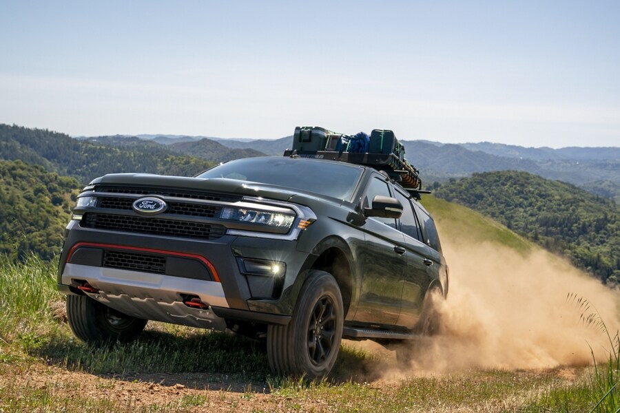A 2023 Ford Expedition SUV being driven up a dirt road