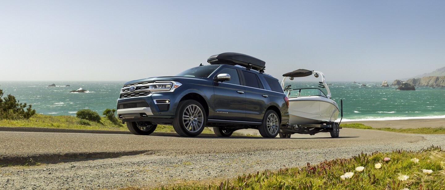 A 2023 Ford Expedition SUV towing a boat
