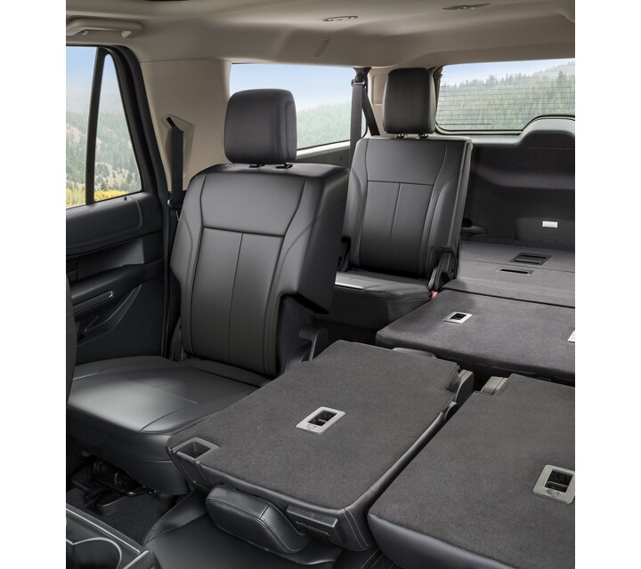 A 2024 Ford Expedition vehicle interior showing Black Onyx seats and fold-down seats for extra cargo space in the back