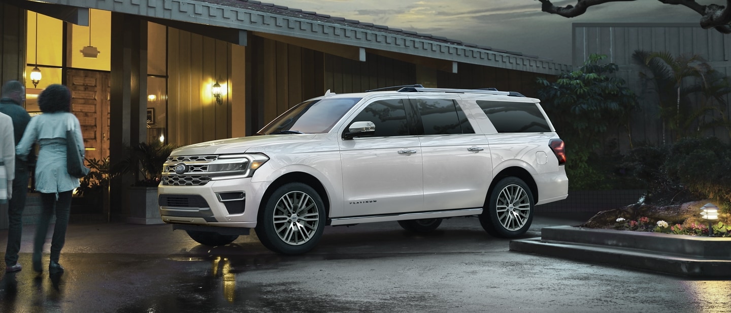 People walking toward a 2024 Ford Expedition SUV parked outside of a building
