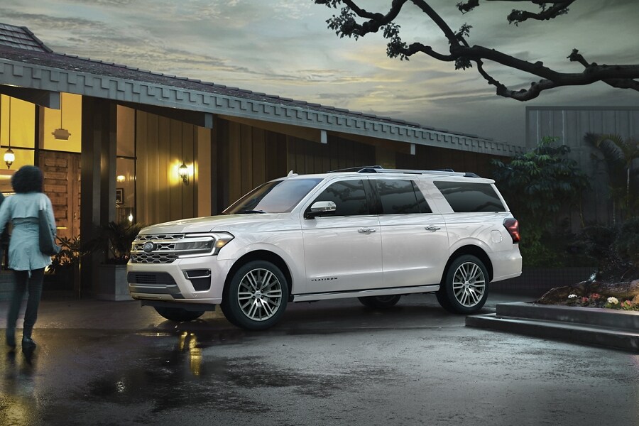 People walking toward a 2024 Ford Expedition SUV parked outside of a building