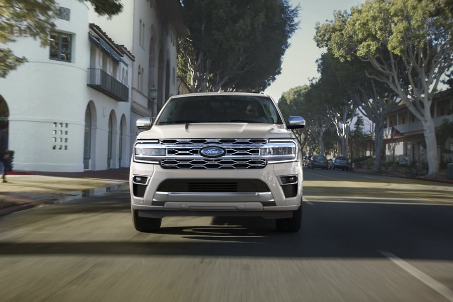 A 2024 Ford Expedition Platinum model being driven on scenic street