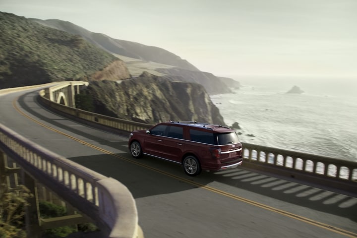A 2024 Ford Expedition Platinum MAX being driven along an oceanside road