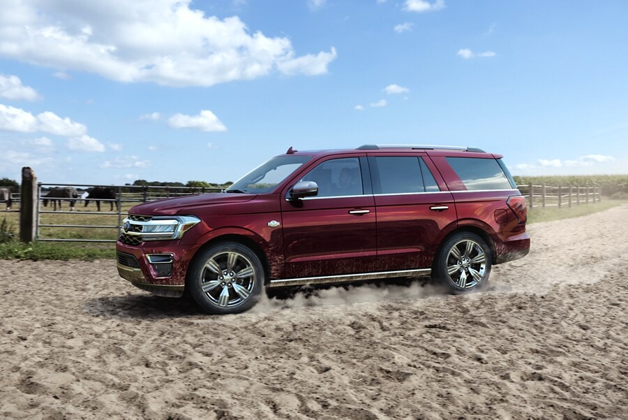 A 2024 Ford Expedition on a sandy, dusty ranch off-road trail