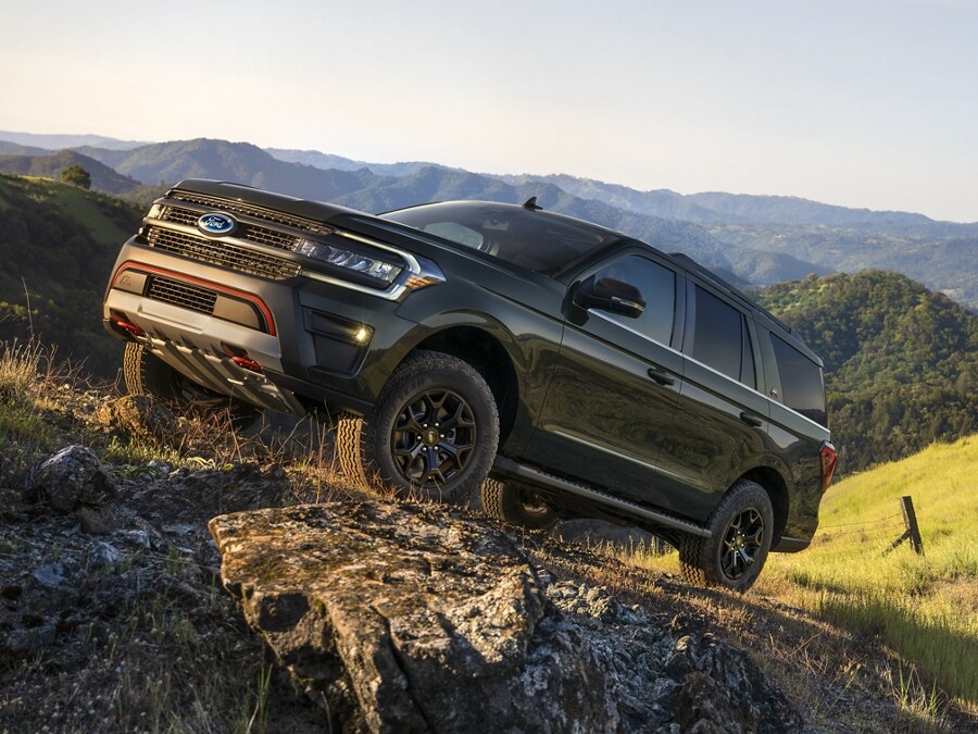 A 2024 Ford Expedition driving up a rocky hillside slope