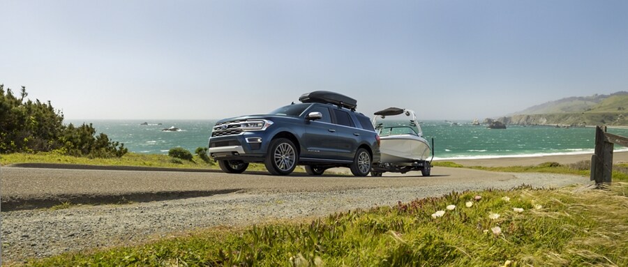 A 2024 Ford Expedition SUV towing a boat