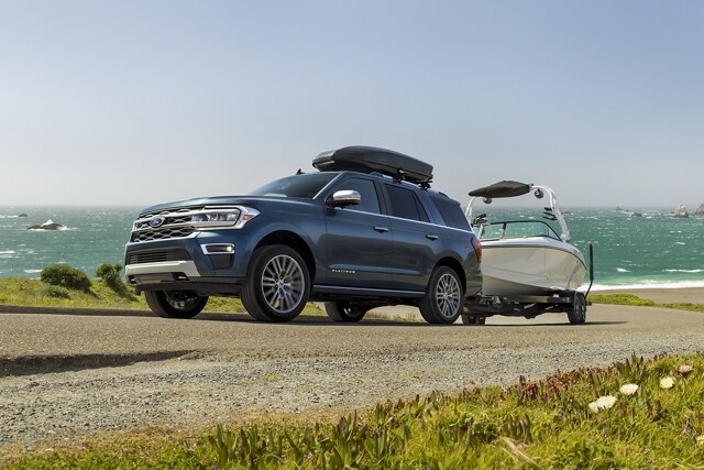 A 2024 Ford Expedition SUV towing a boat