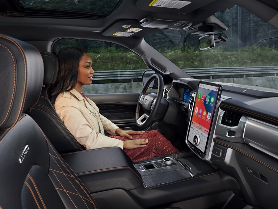 A woman in a 2024 Ford Expedition SUV watching the road while driving hands-free.