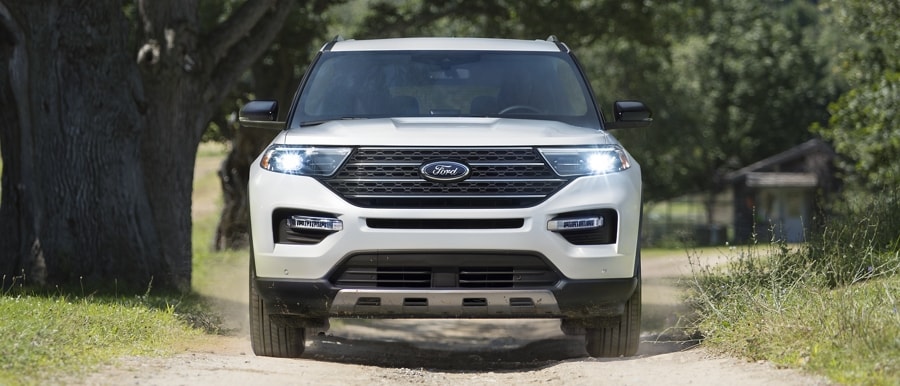 2023 Ford Explorer® King Ranch® model being driven up a dirt road