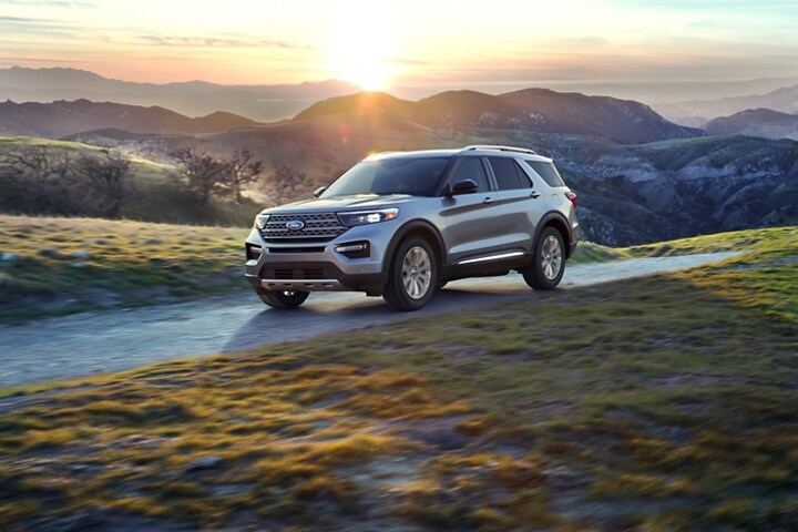 2023 Ford Explorer® SUV in Iconic Silver Metallic being driven in the mountains at sunset
