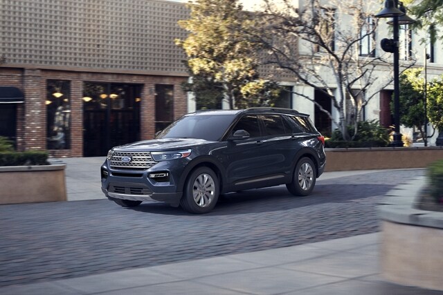 2023 Ford Explorer® Hybrid SUV parked near a storefront