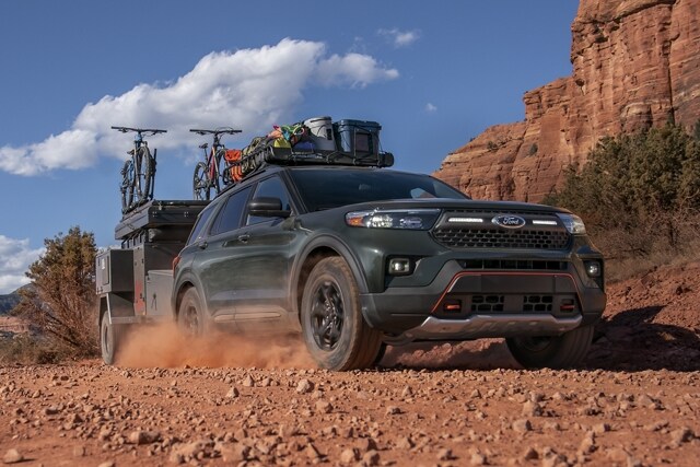 2023 Ford Explorer® Timberline® SUV towing a camper in the desert