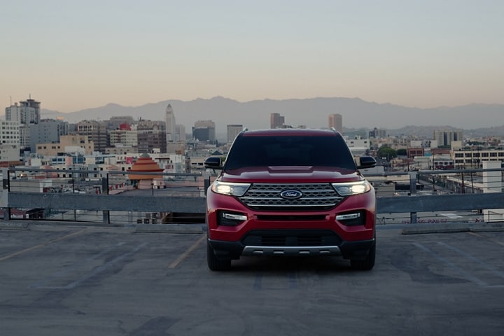 2023 Ford Explorer® Limited Hybrid model in Rapid Red Metallic Tinted Clearcoat on top of a parking structure