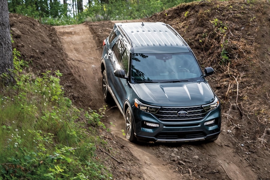 2023 Ford Explorer® XLT model being driven down a steep wooded trail