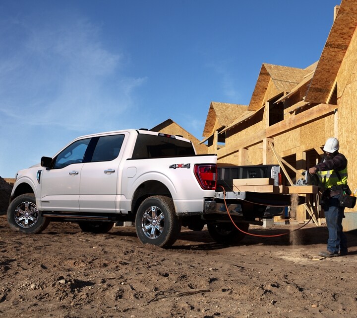 Construction workers working around a 2021 Ford F 1 50