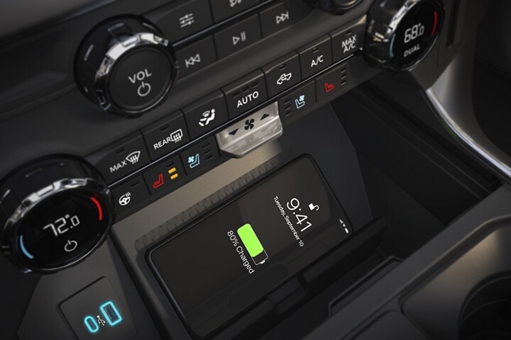 Close-up of a phone charging on the available Qi wireless charging pad in a 2023 Ford F-150®