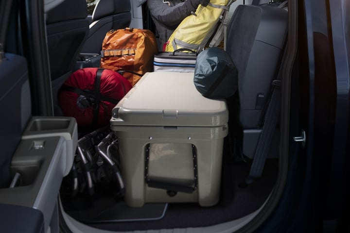 Camping gear on the rear flat load floor in a 2023 Ford F-150®
