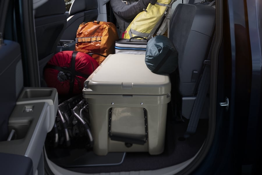 View of the rear cab cargo space with camping gear