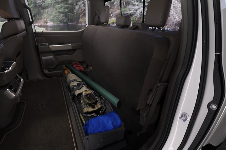 2023 Ford F-150® interior with the back seats folded up to make space for camping gear