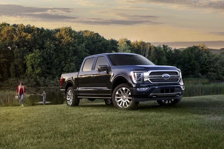 Two people fishing near a 2023 Ford F-150®