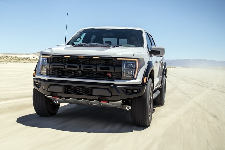 Close-up of the 2023 Ford F-150® Raptor R™ front grille being driven in the desert