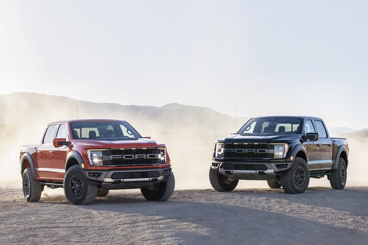 Two 2023 Ford F-150® Raptor® trucks parked in the desert