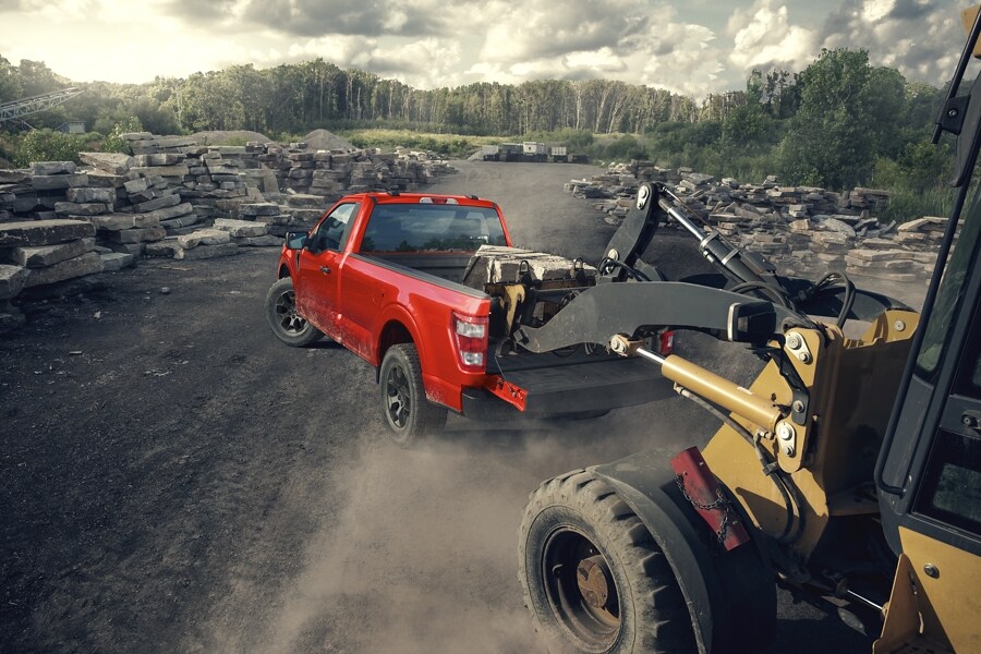 Image of a 2023 Ford F-150® being loaded with large stones in a quarry