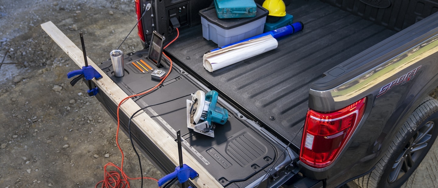Image of the tailgate and bed area with power tools plugged into the Pro Power Onboard outlets