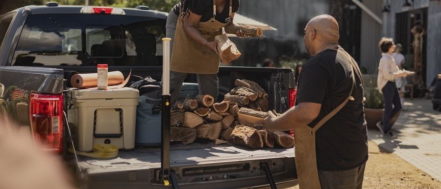 Man and woman unloading items from the bed of a 2023 Ford F-150® pickup
