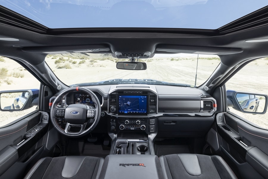 Interior view of the cabin area highlighting the sunroof, front seating area and center console and large display screen