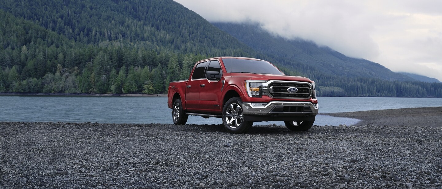 Image of a 2023 Ford F-150® XLT in Rapid Red parked near a mountain lake