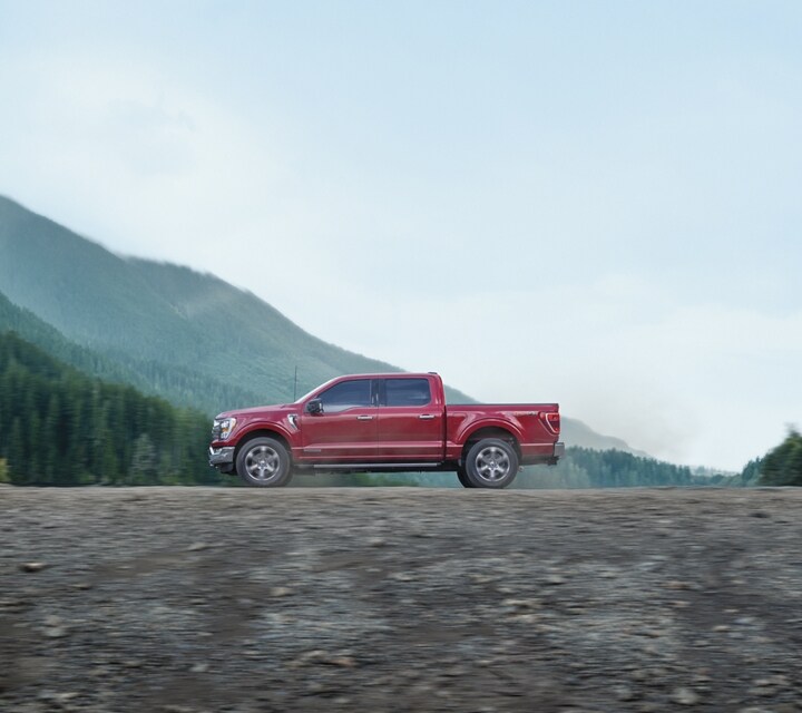 2023 Ford F-150® XLT Crew Cab in Rapid Red being driven on a mountain road