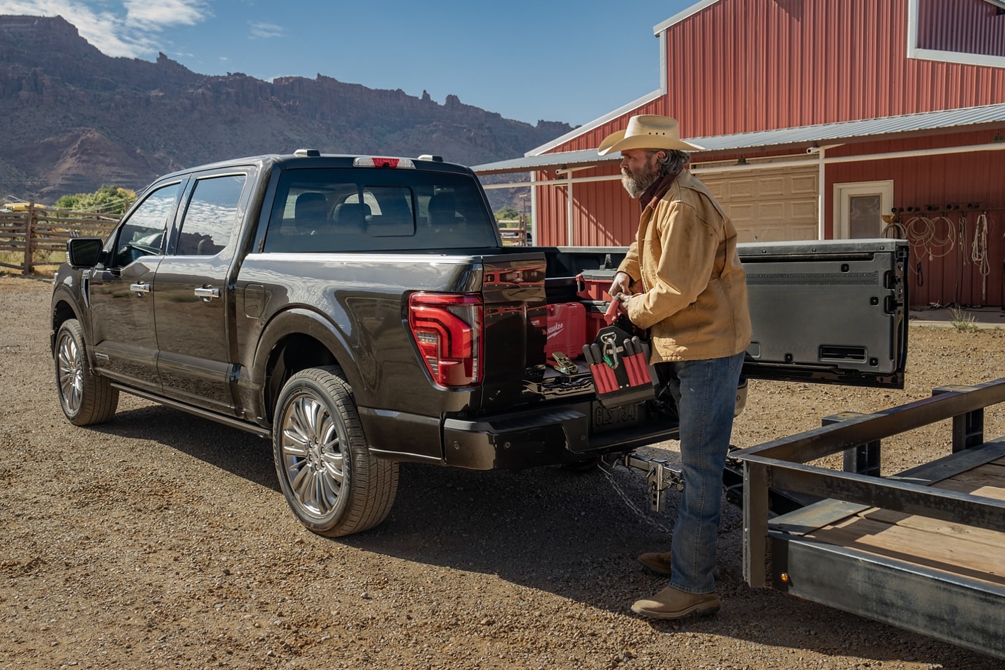  2024 Ford F-150 Limited in Agate Black Metallic with tailgate open and trunk full of tools. 