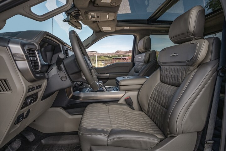 Interior of the 2024 Ford F-150® Platinum® Plus pickup highlighting the front leather-trimmed seats