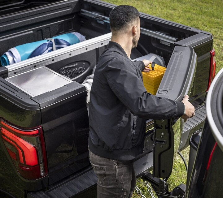 Man opening the Pro-Access Tailgate with a trailer hooked to a 2024 Ford F-150® pickup