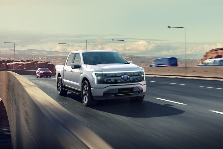 A 2023 Ford F-150 Lightning® being driven on a highway
