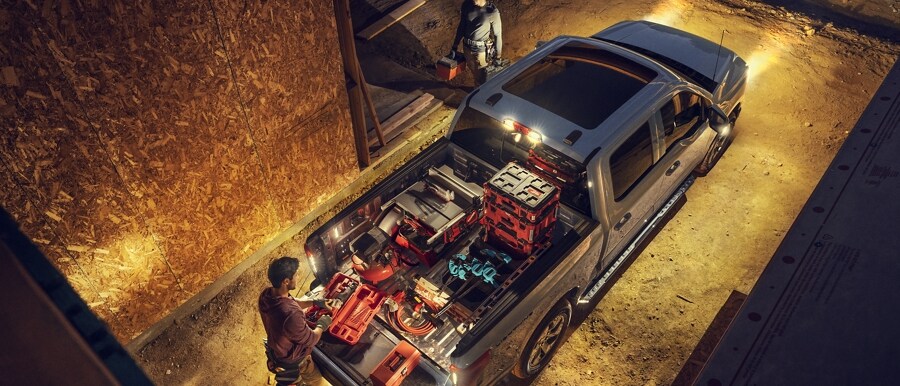 Overhead night view of a 2023 Ford F-150 Lightning® with LED box lighting and zone lights illuminated