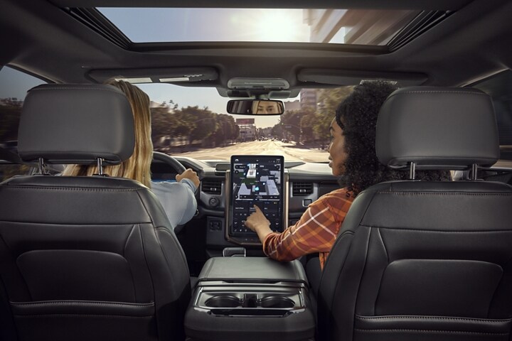 Interior of passenger pointing out destination on touchscreen