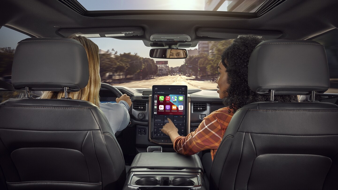 Interior shot as passenger interacts with touchscreen