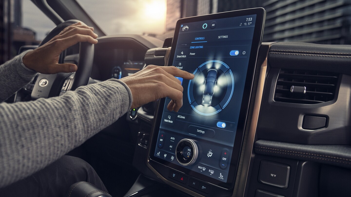 Interior shot of person driving and we see the giant touchscreen