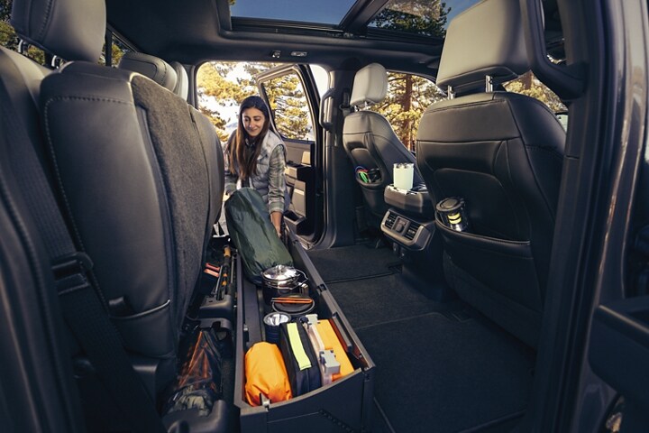 Interior of rear seat raised showing the ample storage space full of stuff