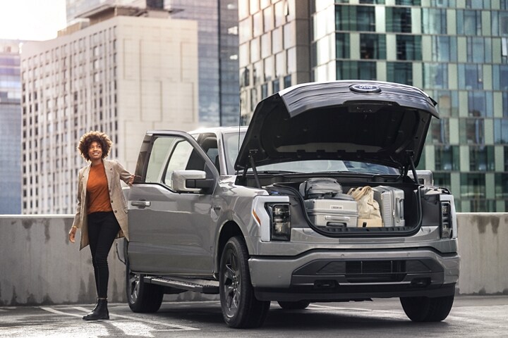A 2023 Ford F-150 Lightning® parked on rooftop with Mega Power Frunk open and full of stuff