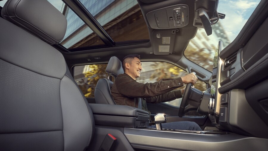 Interior of 2023 Ford F-150 Lightning® with smiling driver