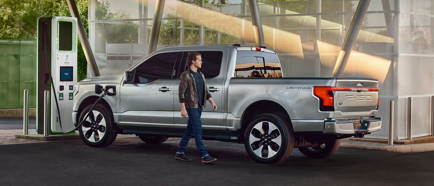 A 2023 Ford F-150 Lightning® getting charged at a public charging station