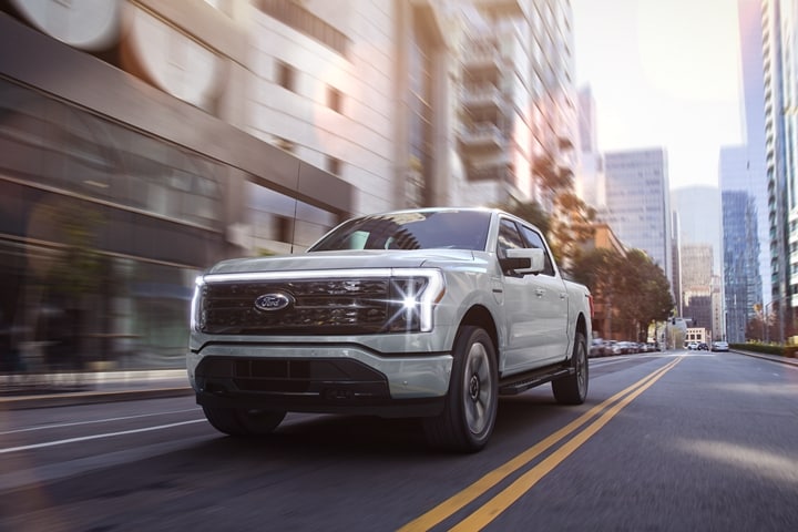 A 2023 Ford F-150 Lightning® Platinum edition driving down street