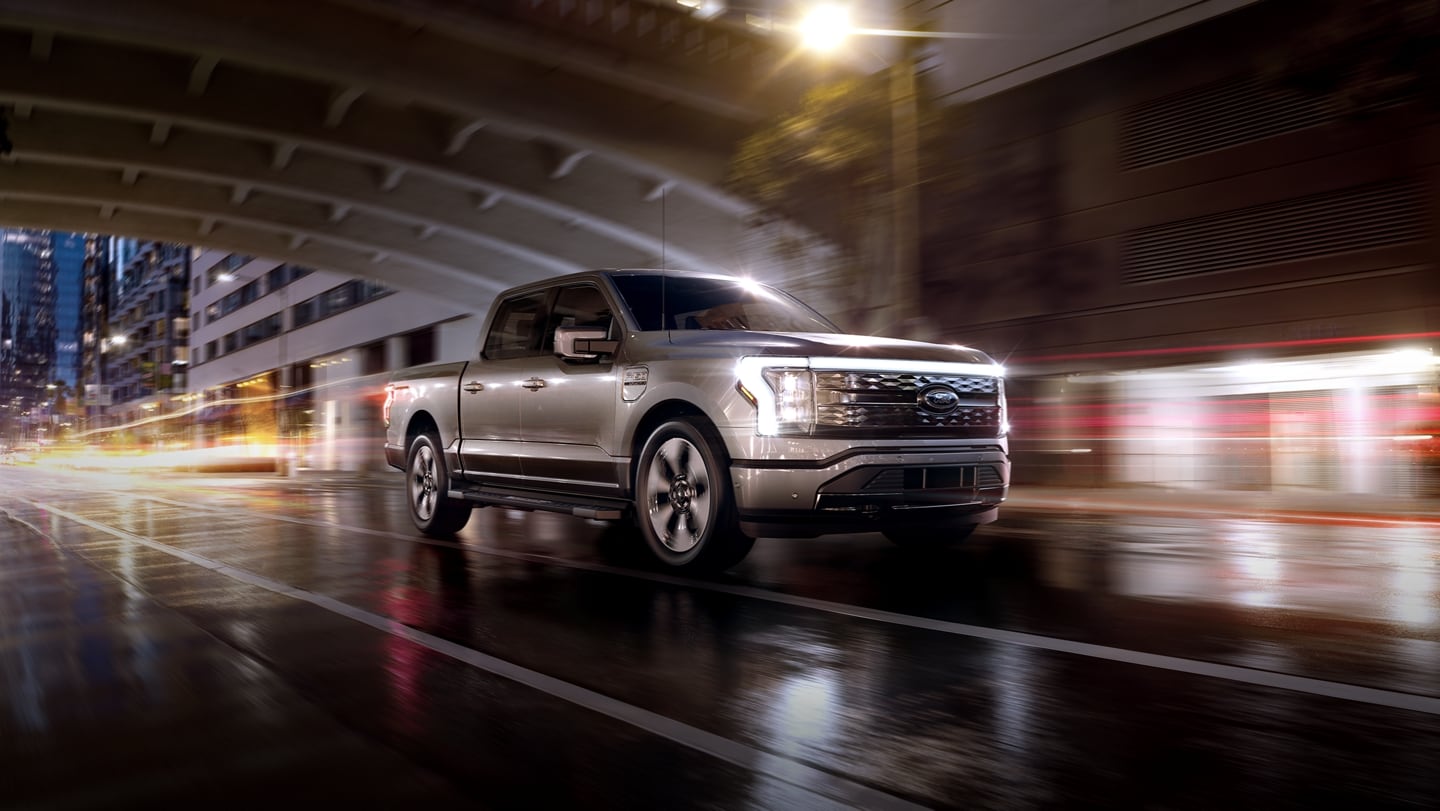 2023 Ford F-150 Lightning driving through the city at night